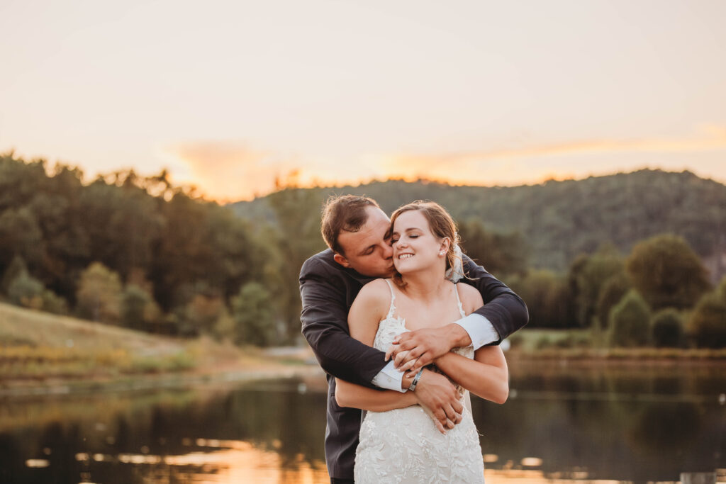 A bride and groom embrace at sunset at Lake Mountain Manor in Princeton, West Virginia. 