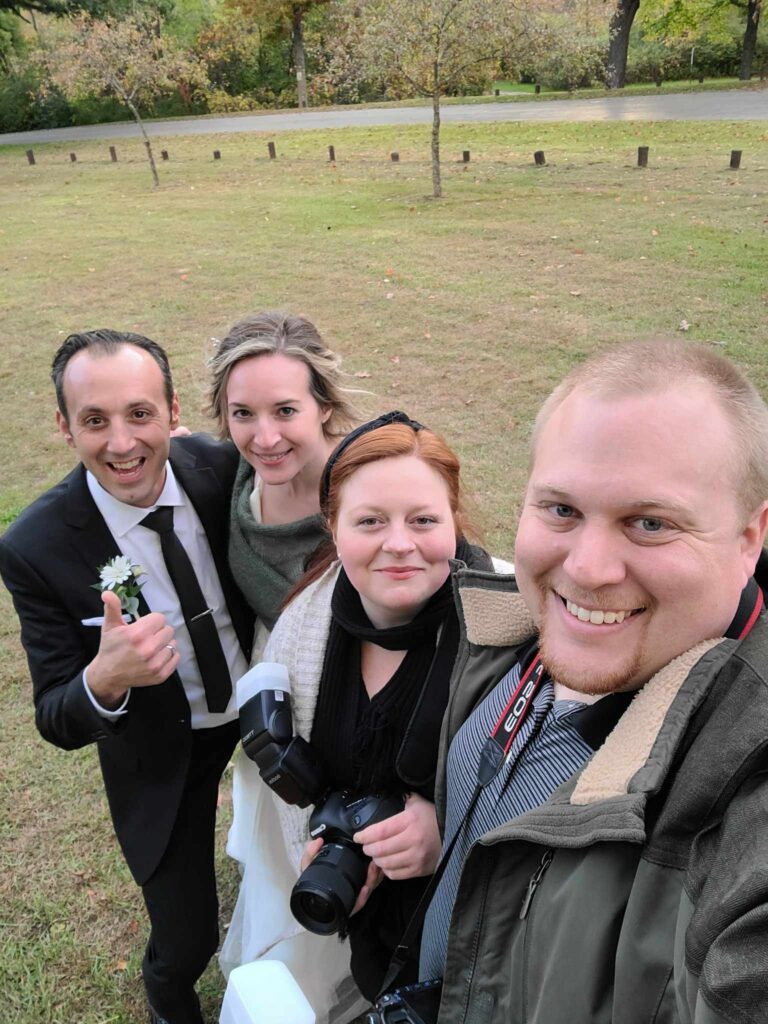 Melena and Brandon Lawson take a photo with a bride and groom in Columbus, Ohio. 