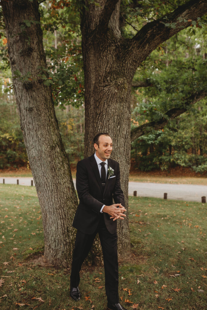 A man sees his bride to be for the first time and smiles in exitement.