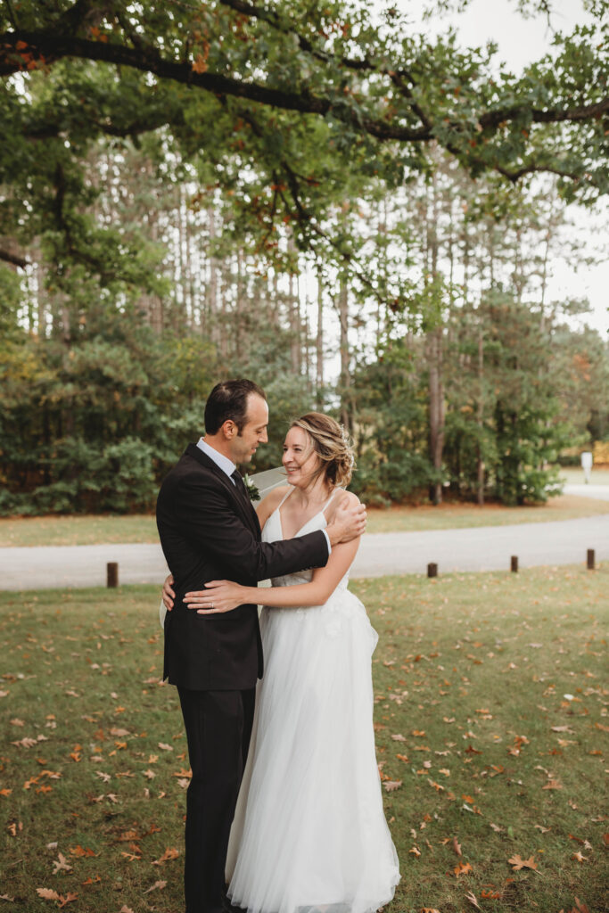 A soon to be husband and wife embrace in excitement after a first look at each other before the wedding. 