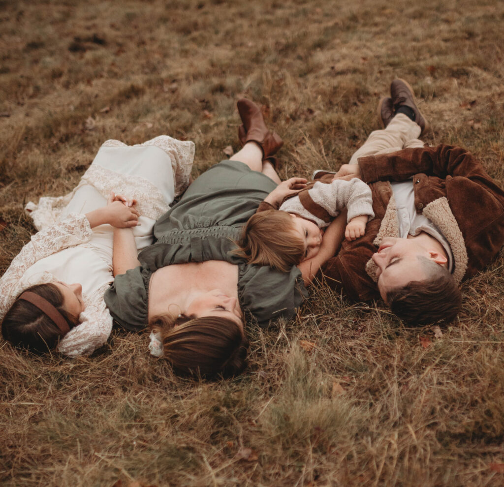 A family snuggle in the grass together at Pipestem State Park in West Virginia.