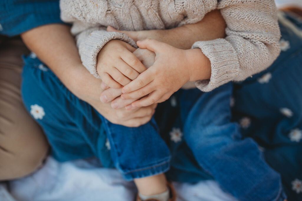 A close up photograph of a boy holding his mothers hands at Pipestem State Park in West Virginia.