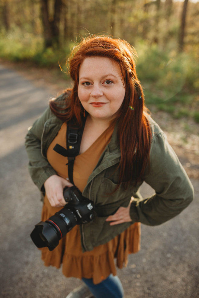 Melena Lawson holds her camera and smiles for a photo in Beckley, West Virginia.