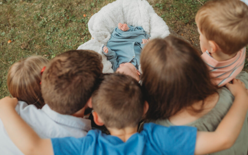 A family huddle around a newborn baby and admire it at Little Beaver State Park in Beckley, West Virginia. 