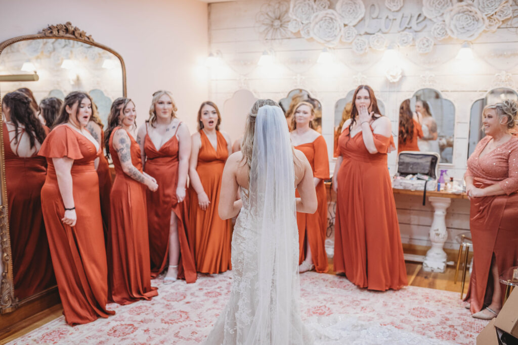 Bridesmaids see the bride for the first time before the wedding at Barn on Unity Farm in Princeton, West Virginia.