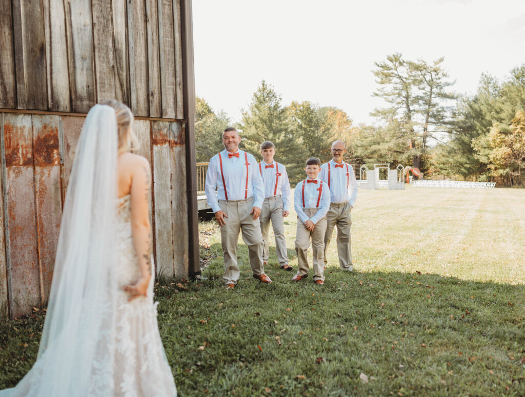 A family of men see the bride for the first time at Barn on Unity Farm in Princeton, West Virginia. 