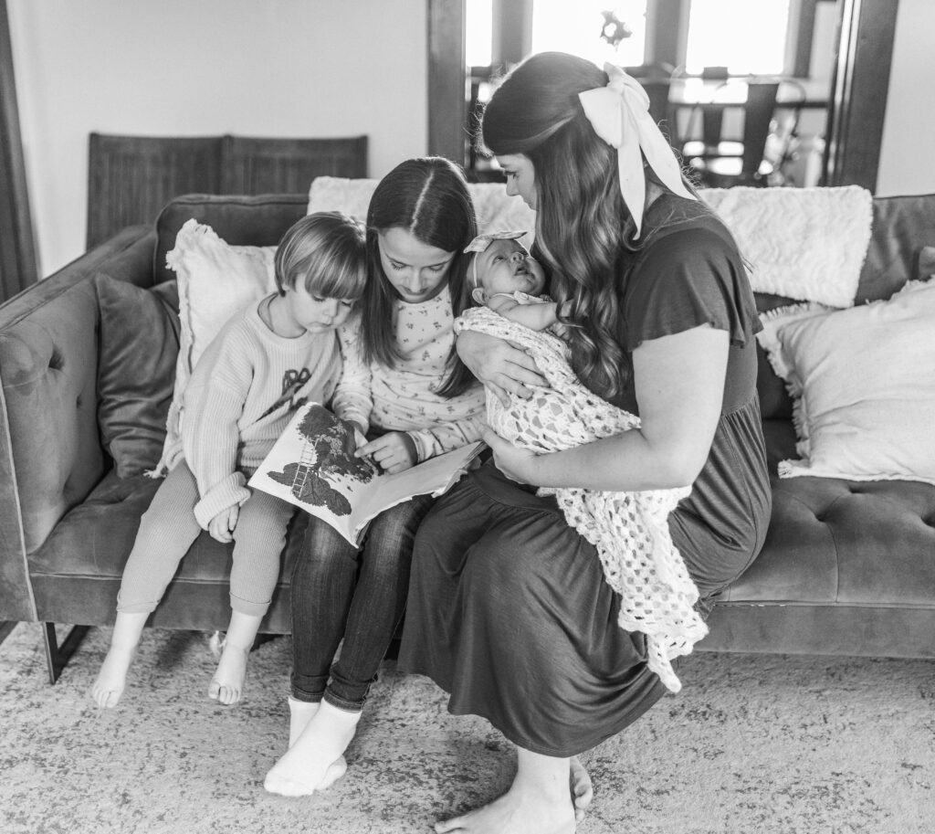 A family reading a book at an in home family photography session in Bluefield, West Virginia.