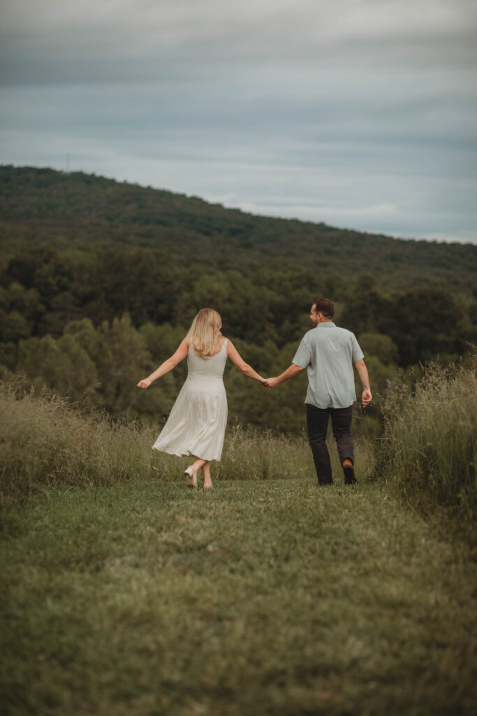 A woman and man hold hands during engagement photos in Blacksburg, Virginia