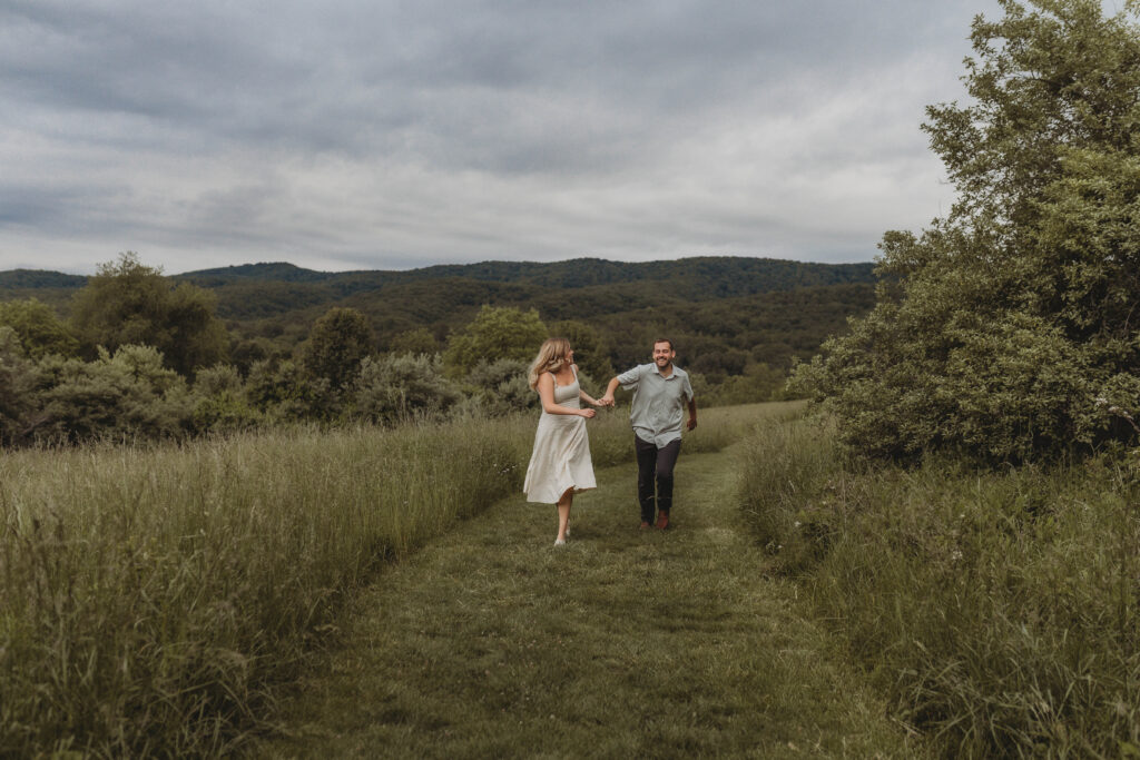 A couple run and play during engagement photos in Blacksburg, Virginia.
