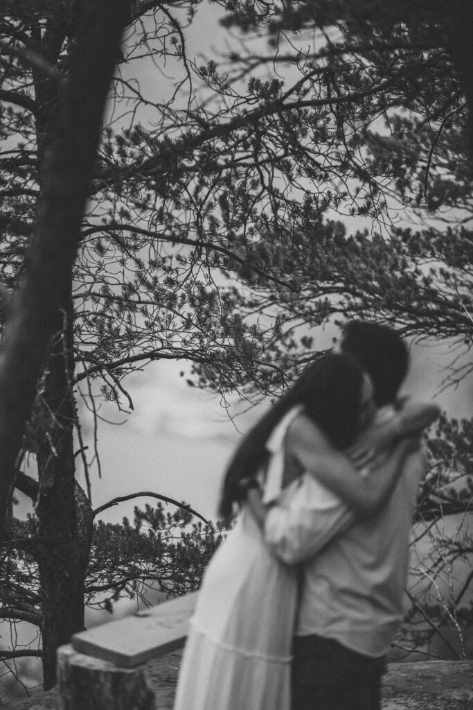 A couple hug together during their New River Gorge engagement photos.