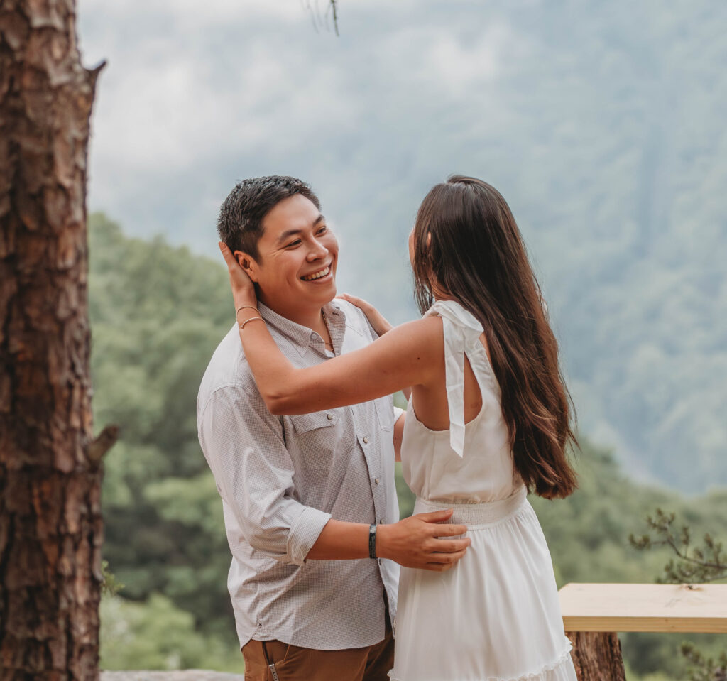 Couple laughs during dance at New River Gorge engagement photos.