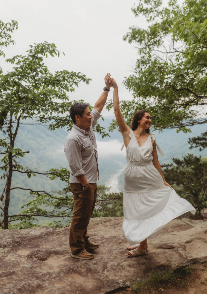 A couple dances together during their New River Gorge engagement photos.