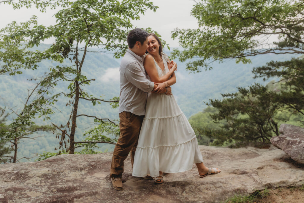 A couple dances together during their New River Gorge engagement photos.