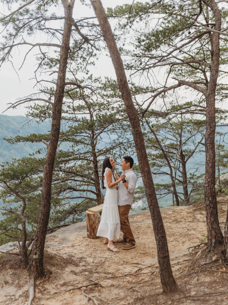 A couple dances together during their New River Gorge engagement photos.