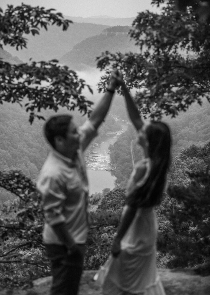 A couple dances together during their New River Gorge engagement photos.
