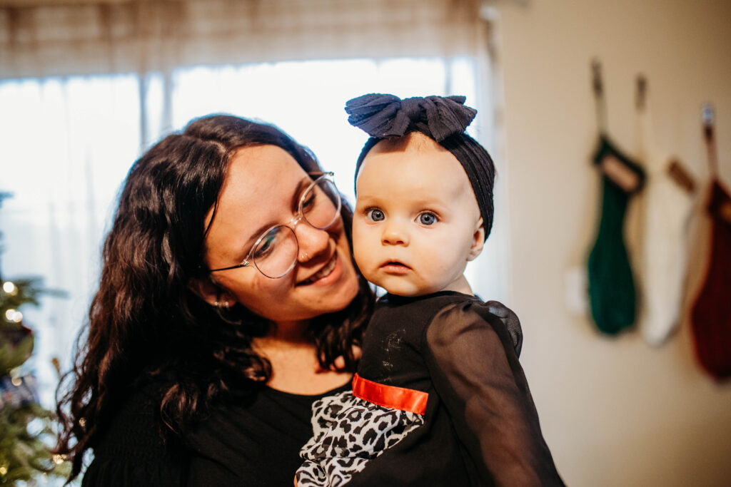 A mother and child cuddle at an at home winter family photo session.