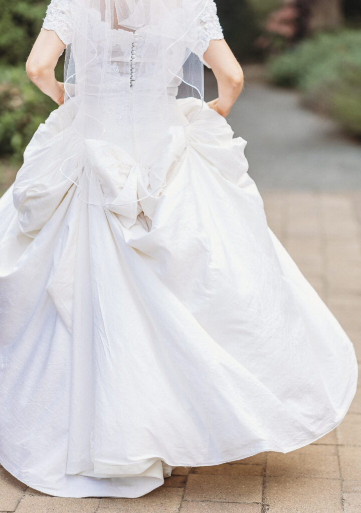 The bride walks away at a Hahn Horticulture Wedding in Blacksburg, Virginia. 