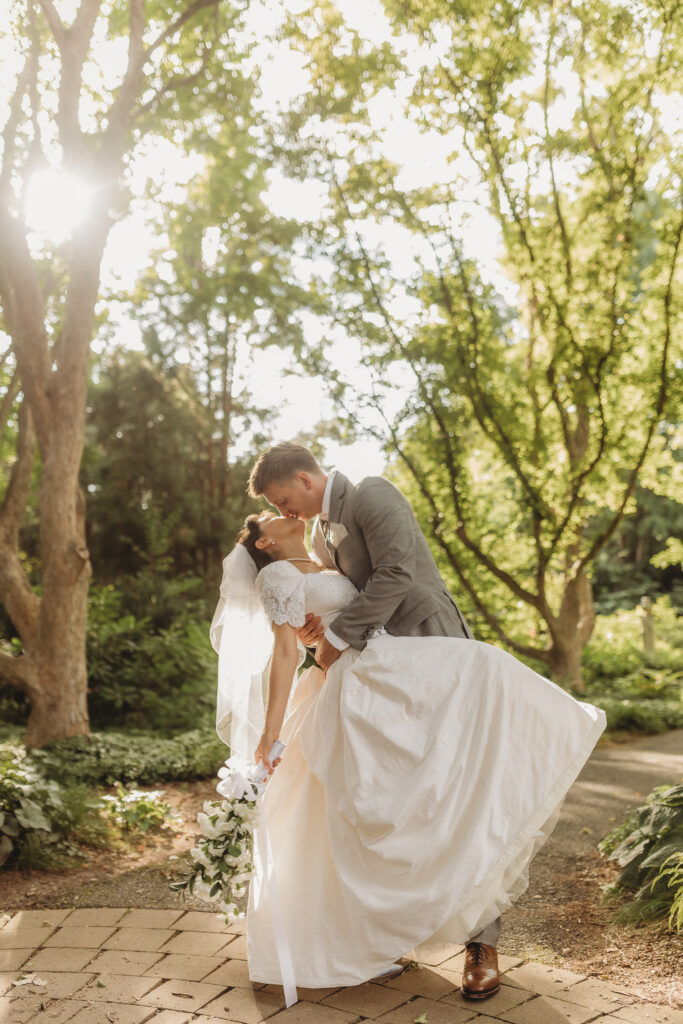 The groom kisses the bride at a Hahn Horticulture Wedding in Blacksburg, Virginia. 
