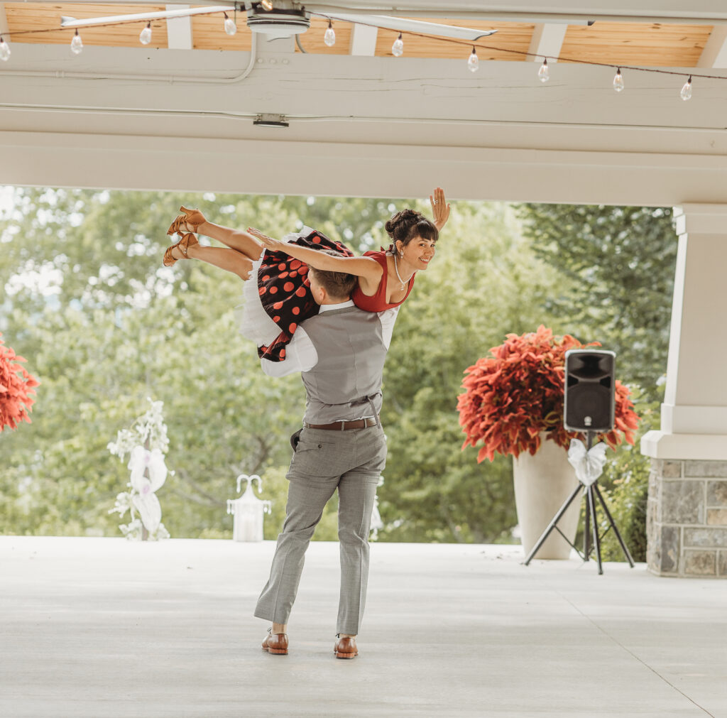 The groom lifts the bride during a dance at a Hahn Horticulture Wedding in Blacksburg, Virginia. 