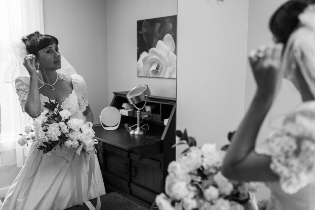 A bride puts on her earrings at a Hahn Horticulture Wedding in Blacksburg, Virginia. 