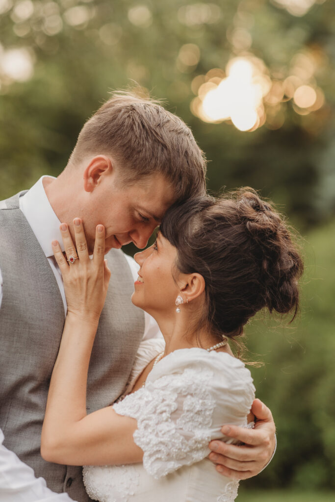 Th bride and groom look at one another at a Hahn Horticulture Wedding in Blacksburg, Virginia. 