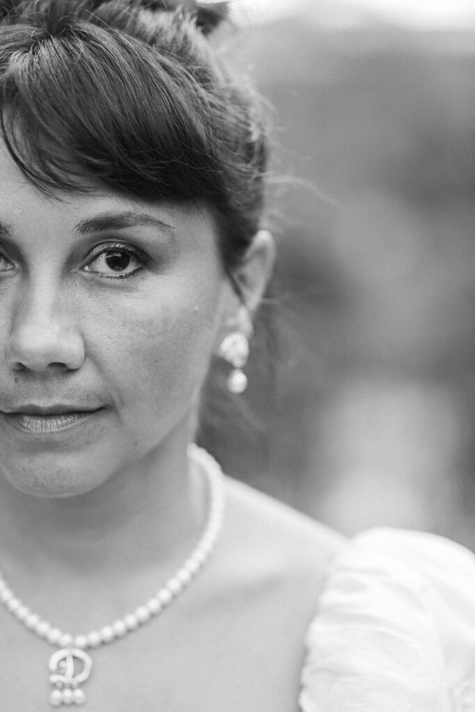 A bride looks into the camera at a Hahn Horticulture Wedding in Blacksburg, Virginia. 