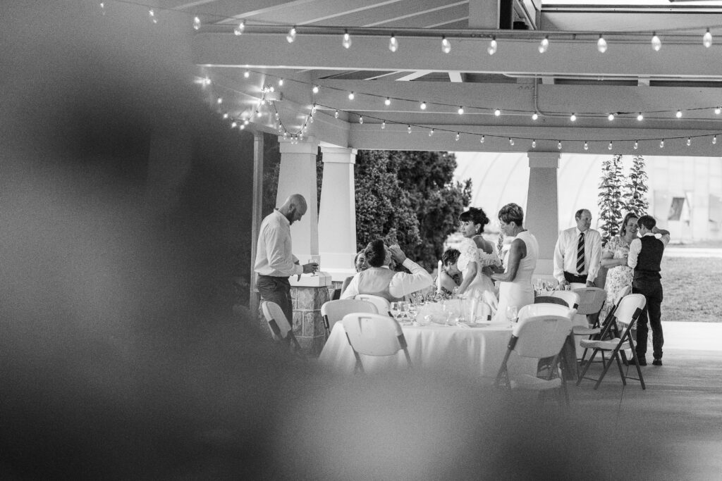 Mother of groom zips bride's dress at a Hahn Horticulture Wedding in Blacksburg, Virginia. 