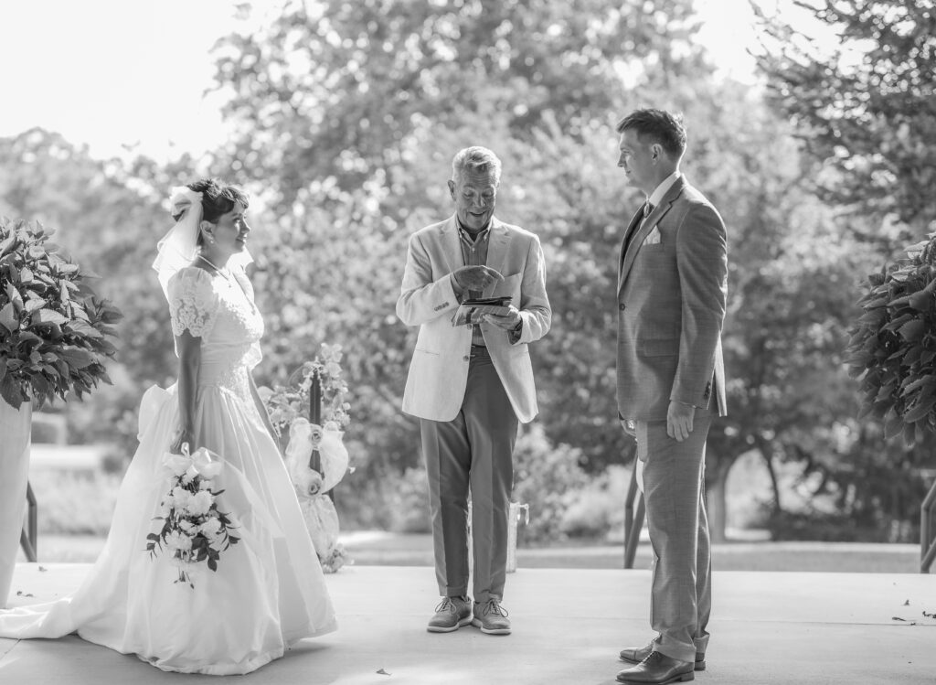 The bride and groom stand up together at the ceremony at a Hahn Horticulture Wedding in Blacksburg, Virginia. 