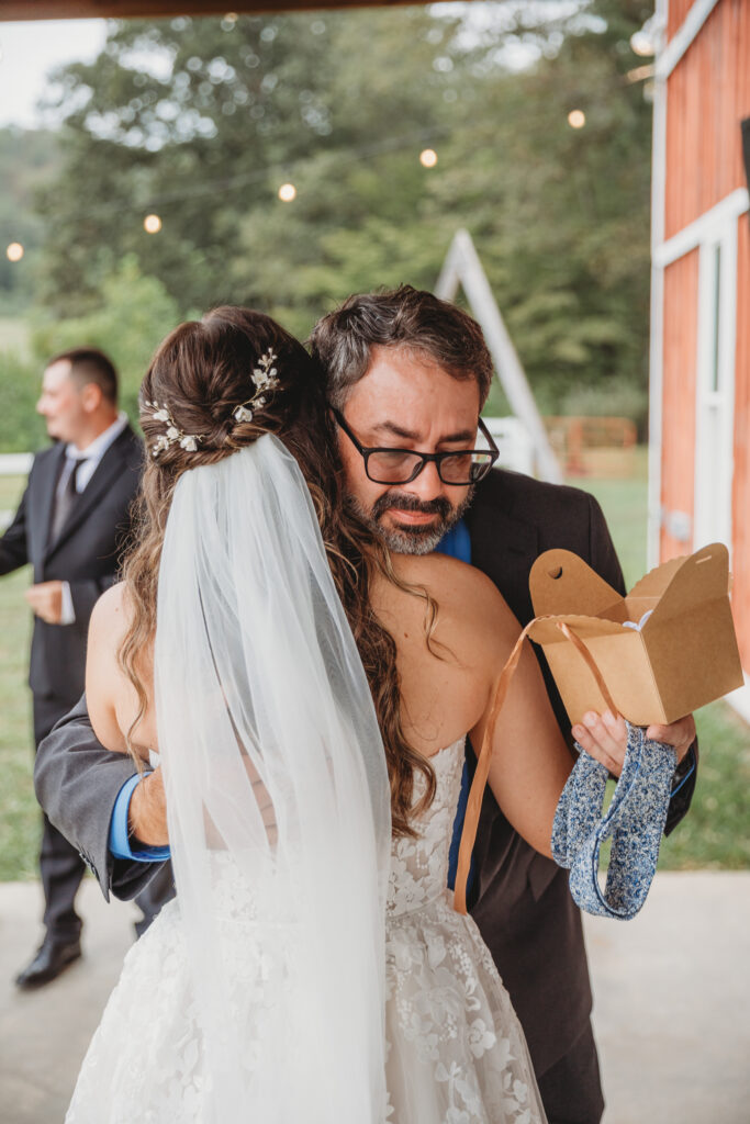 A dad hugging a bride at a Vintage Valley Wedding. 