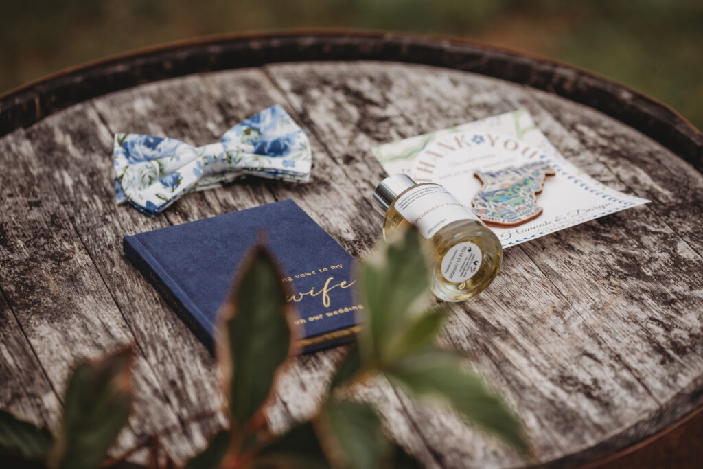 Vows and cologne sitting on a barrel 