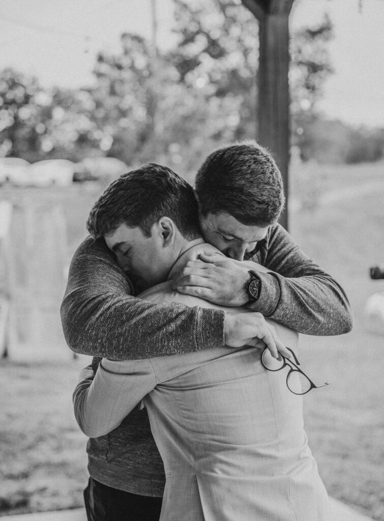 A groom hugging his brother