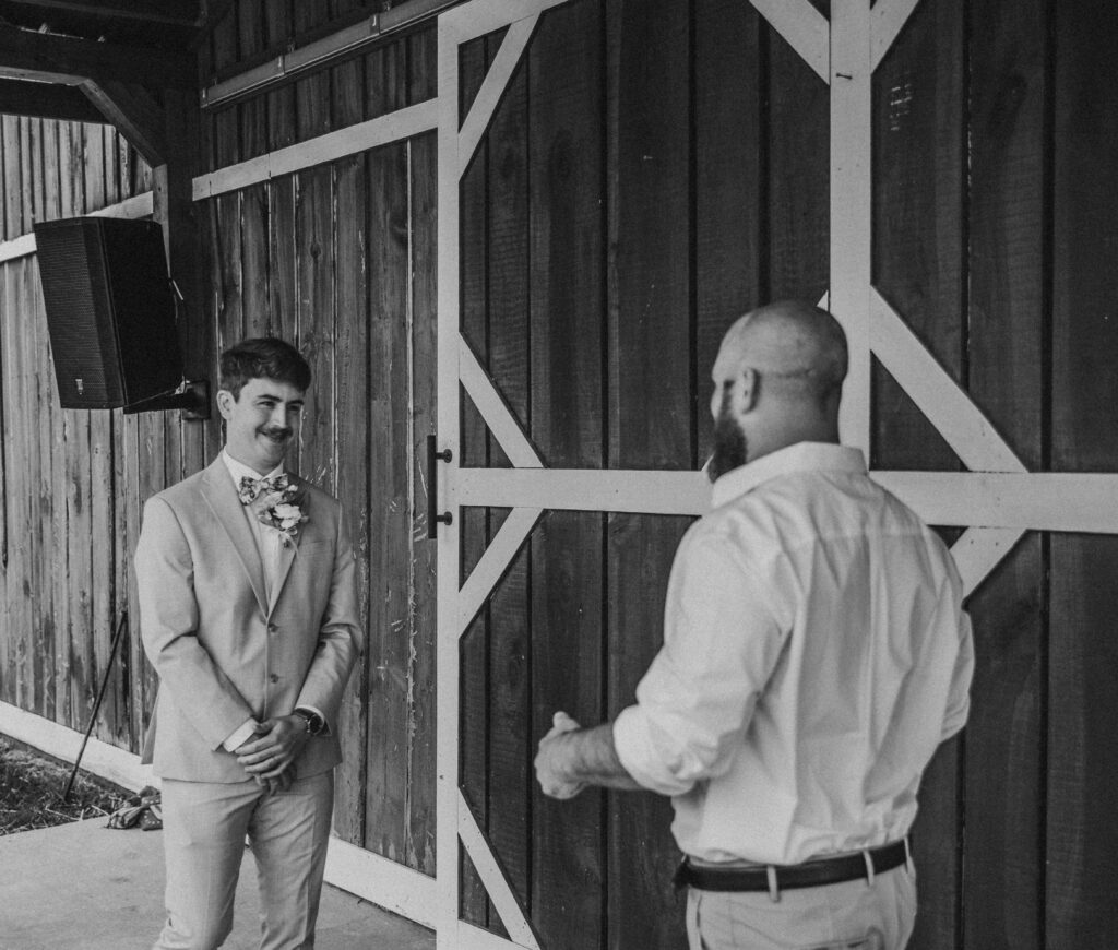 A first look between a groom and brother