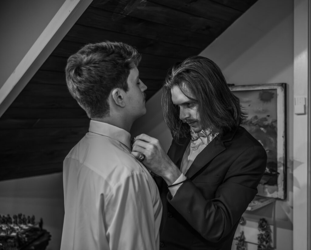 Groom adjusting his tie at a Vintage Valley Wedding. 