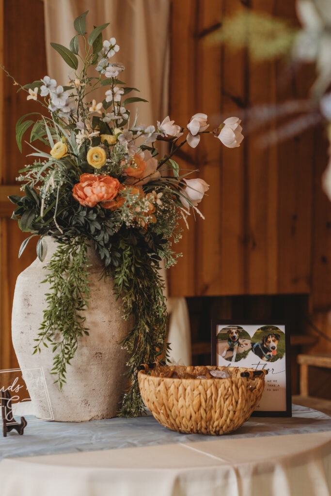 A plant with flowers and a photo of a dog