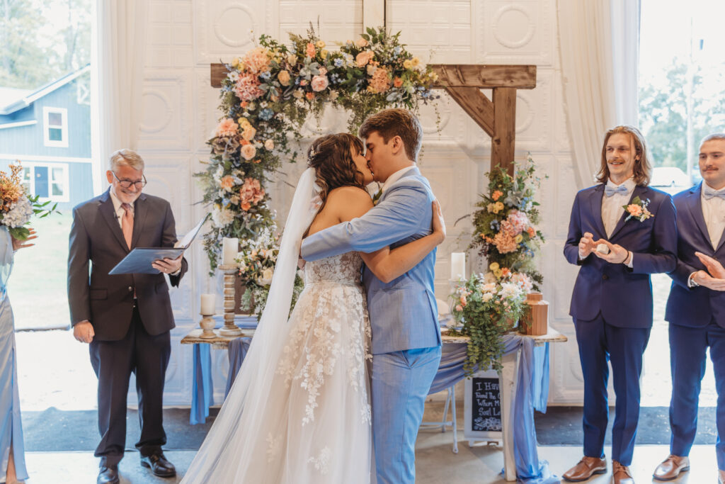 The groom kisses the bride at a Vintage Valley Wedding. 