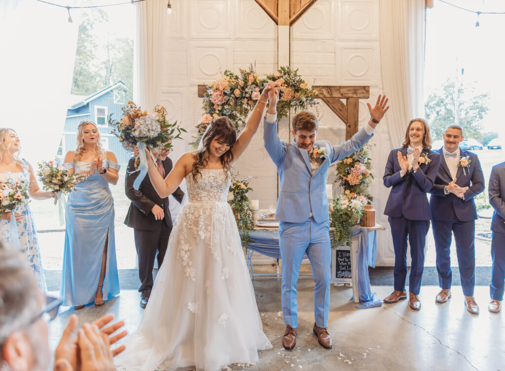 The bride and groom cheer because they are married! 