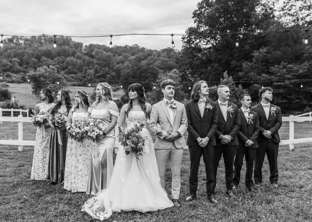 The entire wedding party takes a serious photo 