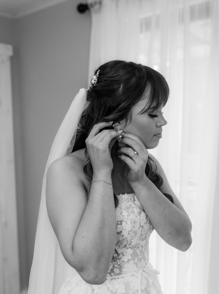 Bride putting on her earring at a Vintage Valley Wedding. 