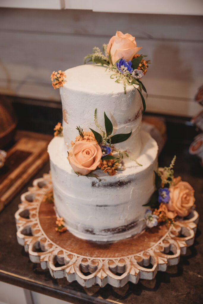 A beautiful white vanilla wedding cake with flowers 