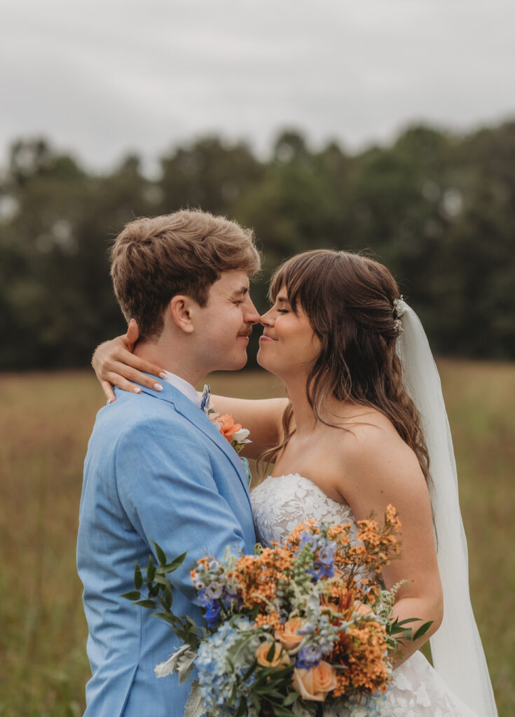 The bride and groom touch noses