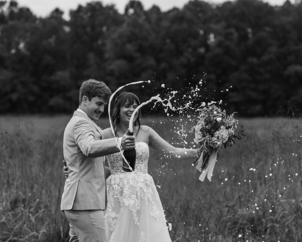 The bride and groom pop champagne
