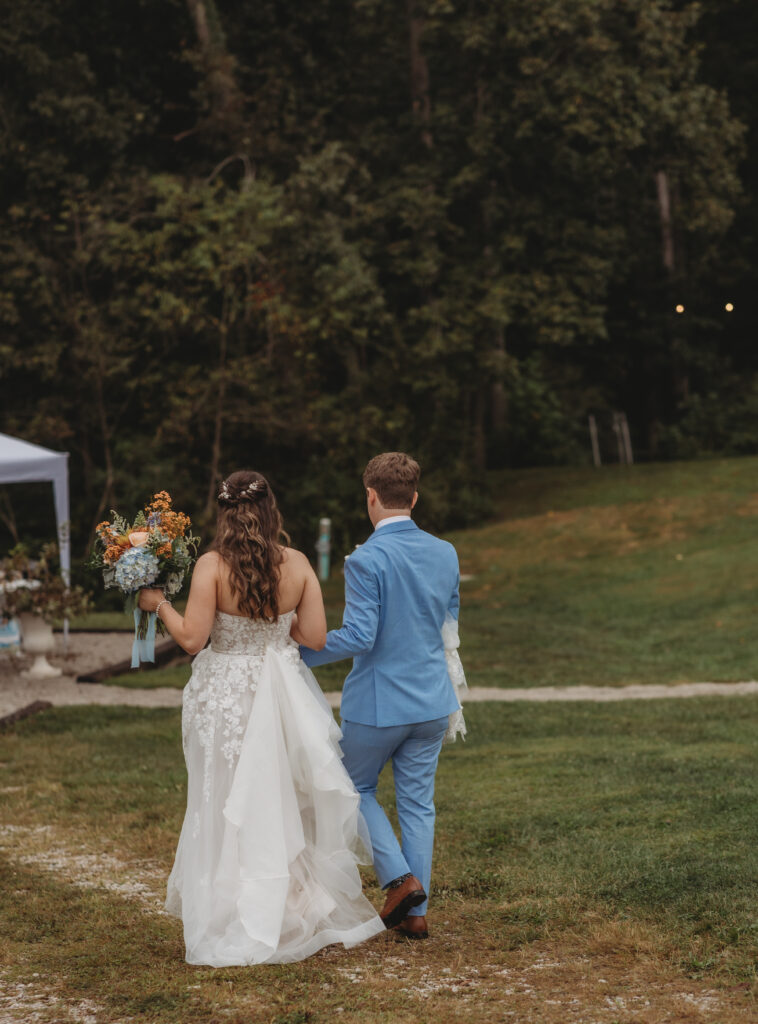 The bride and groom walk away at a Vintage Valley Wedding. 