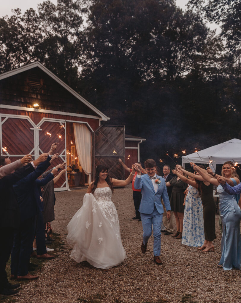 The bride and groom hold hands as they walk at a Vintage Valley Wedding. 