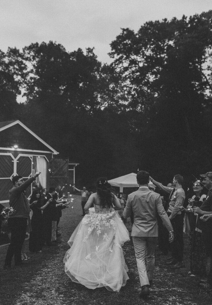 The bride & groom walking away at their sparkler exit at a Vintage Valley Wedding. 
