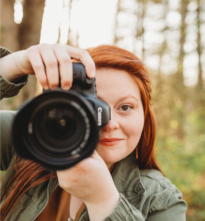 Melena Lawson, a West Virginia Wedding Photographer, looking at the camera and holding her own camera. 